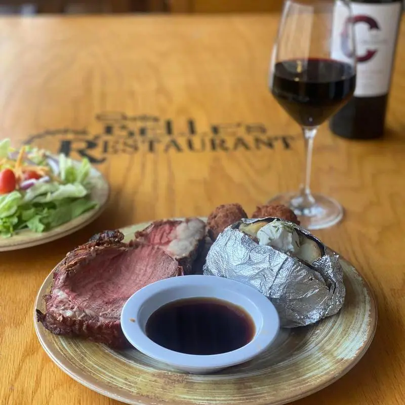 Prime rib with baked potato and wine