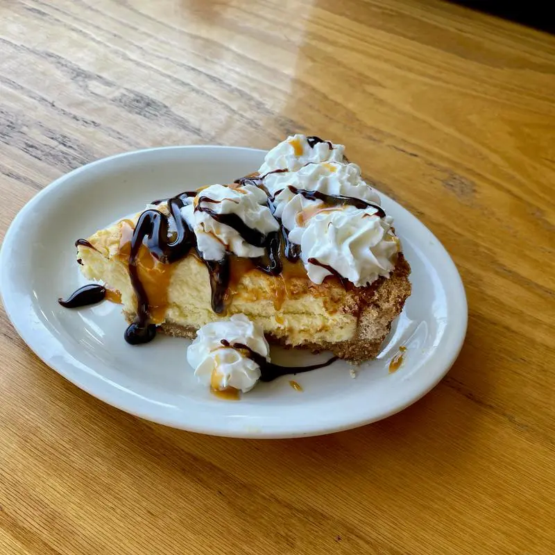 Cheesecake with caramel, chocolate, whipped cream