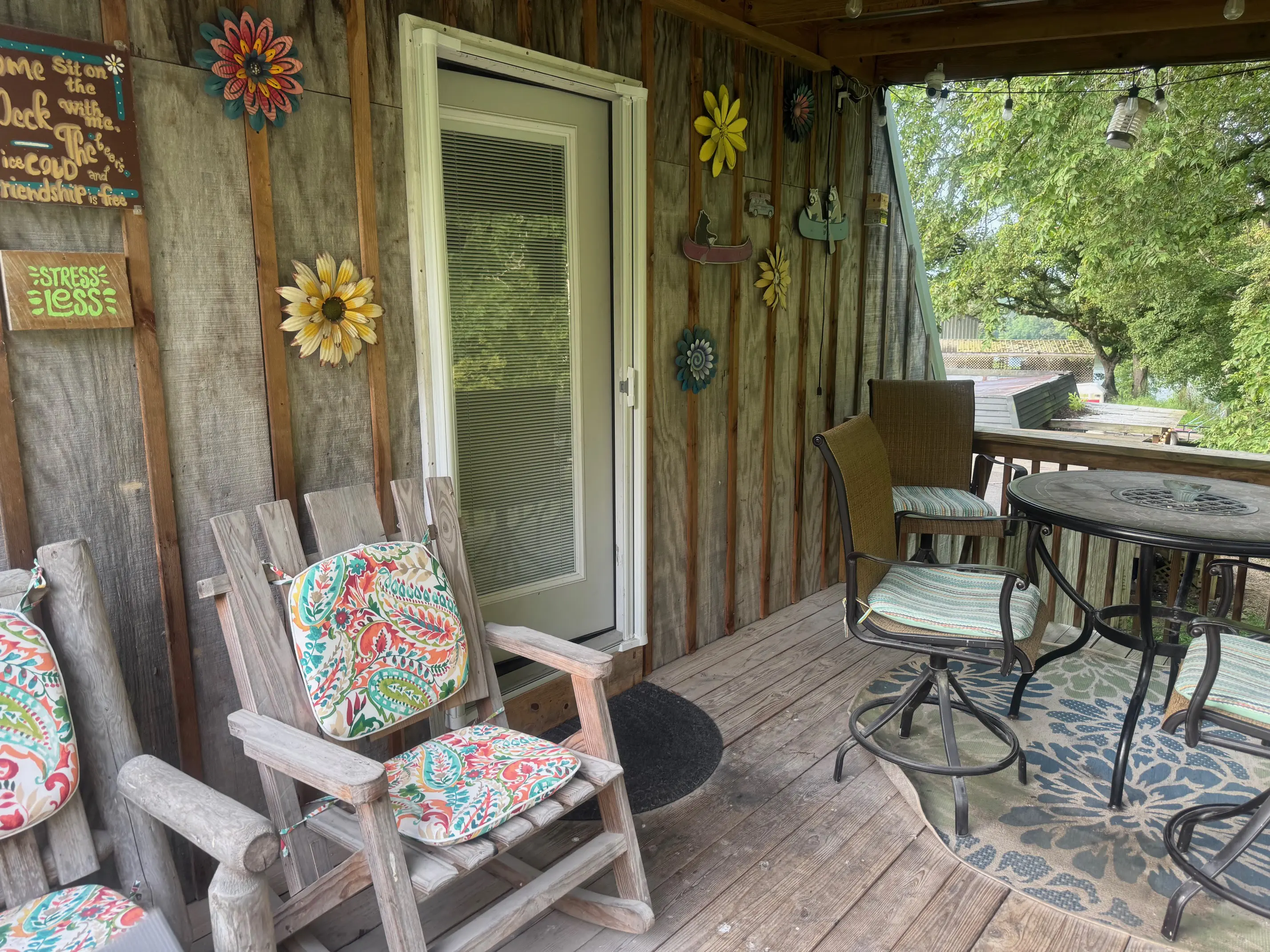 Rustic wooden porch with colorful cushioned chairs