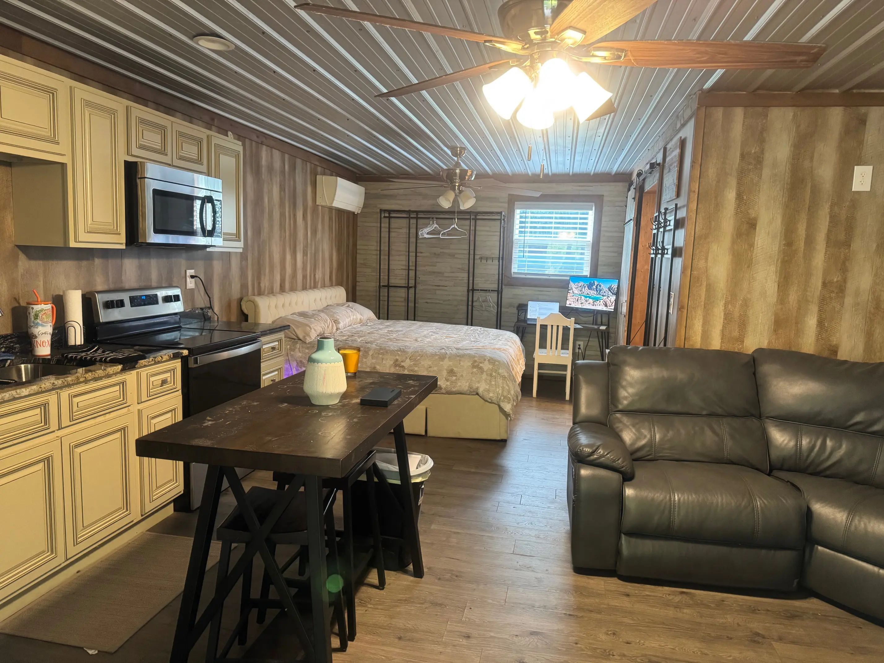 Cozy studio apartment with kitchenette and bed