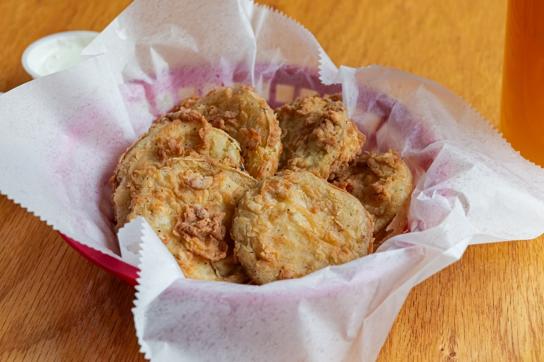 Basket of fried pickles with dipping sauce