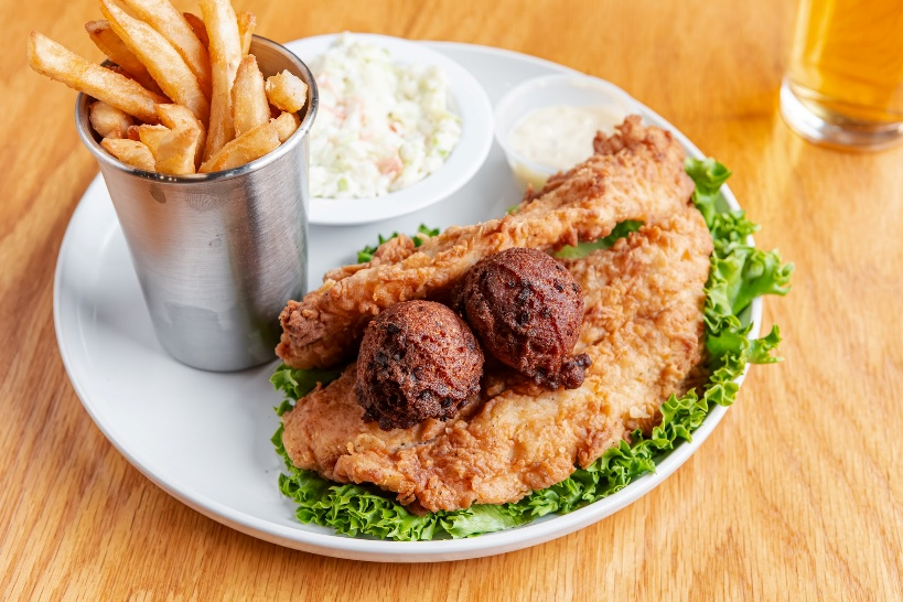 Fried fish with hush puppies, fries, coleslaw